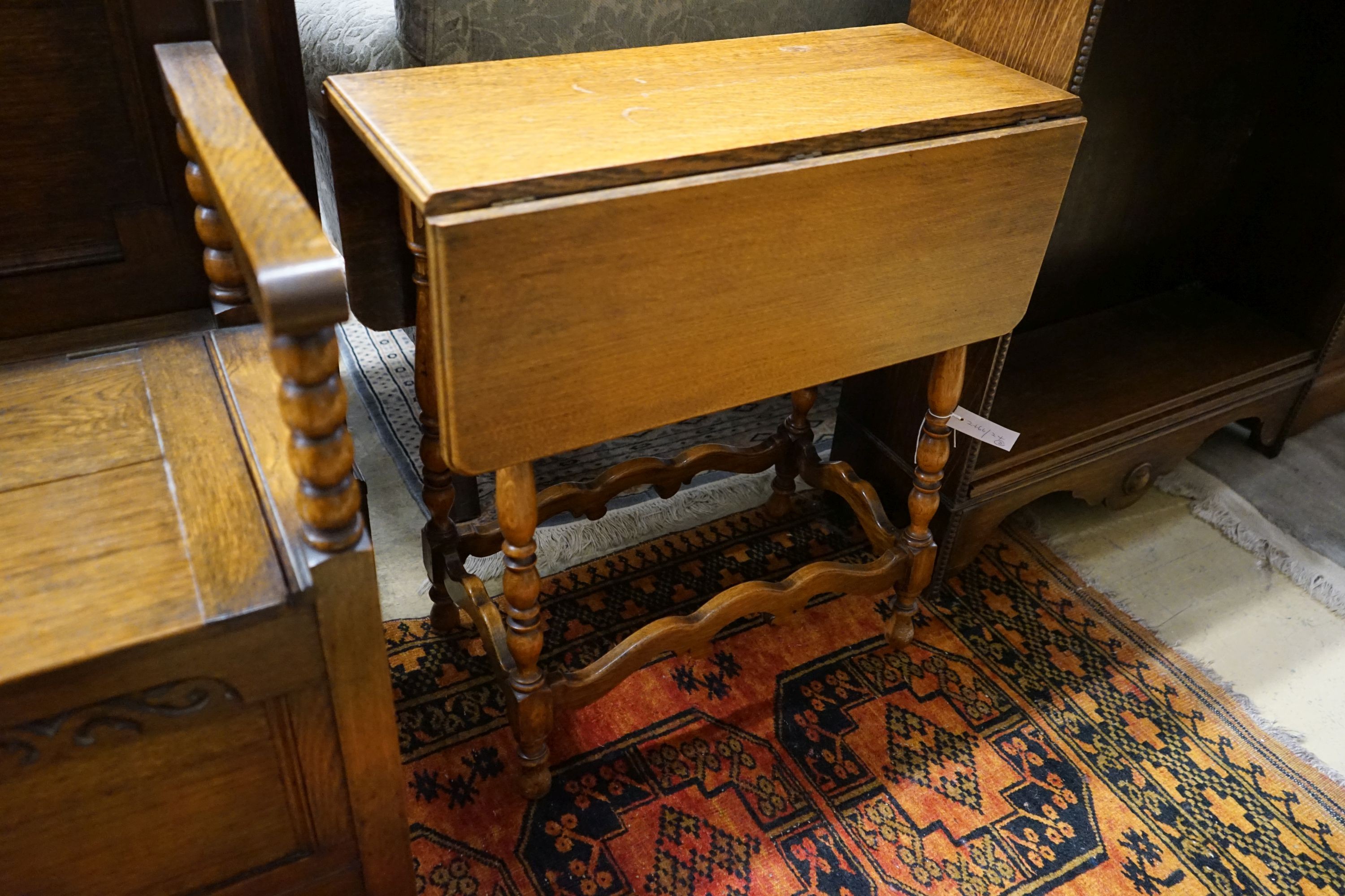 A small oak open bookcase, width 76cm, depth 27cm, height 109cm, together with a small oak gateleg occasional table